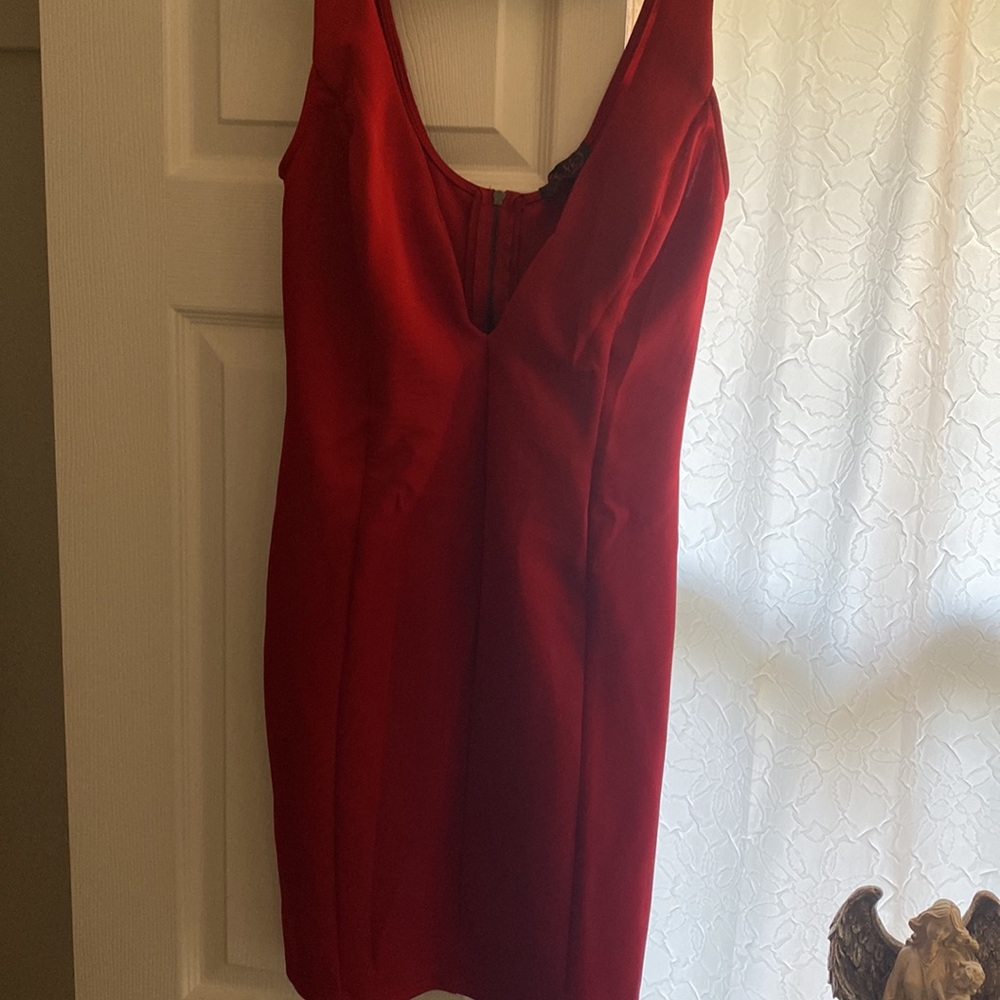 Form fitting red dress above knees